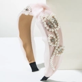 Pink mesh headband featuring pearl and rhinestone floral patterns on a white pedestal - Light Pink