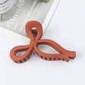 Matte brick red oversized bow hair claw clip for thick hair, secure grip hair accessory - Orange
