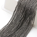 Close-up of 2mm faceted dark grey glass beads for DIY jewelry and beaded necklaces - Silver