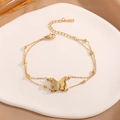 Double-layered gold stainless steel butterfly bracelet with metal beads on marble tray - Double Layer Butterfly Bracelet / Gold