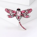 Detailed macro view of dragonfly brooch featuring pink crystals and silver metal finish - Antique Silver Pink