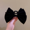 Elegant black velvet bow hair claw clip featuring a stylish gold metal logo embellishment - Black Velvet With Logo Style / Black Double-Sided Bow Hair Claw