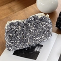 Grey velvet clutch bag with silver sequins and pearl clasp on a wooden desk - Silver