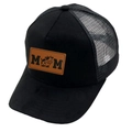 Detail of black trucker hat featuring brown leather MOM patch with cartoon cow design - MOM / Black