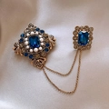 Vintage gold plated double brooch with blue crystals and pearls on silk background - Retro Court Chain Brooch