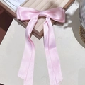 Pink ribbon bow hair clip with elegant long streamers on wooden display tray - Pink