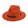 Detailed macro view of an orange wool fedora hat with a black leather belt and gold buckle - Caramel color