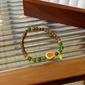 Detail of beaded bracelet with wooden beads, green jade, and orange gourd charm - 6# Gold Hulu Leaf