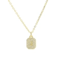 Macro detail of a gold plated square pendant necklace with pave zircons and letter J - Necklace J
