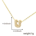 Golden necklace featuring a small crystal pavé letter U pendant with size measurements - Gold Letter-U