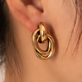 Three-ring intertwined gold titanium earrings with polished 18K finish on model ear - Retro Triple Nested Rings (BJGE0728)