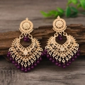 Vintage bohemian hollow heart earrings with purple beads on a rustic wooden surface - Purple