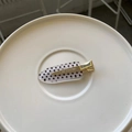 Detailed view of an oval polka dot hair clip with a gold metal duckbill fastener - White Polka Dot Oval Style (HDJ-11) / Silver Traceless Clip / Silver