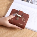 Brown leather wallet for women featuring leaf cutouts and a gold leaf metal pendant - Brown