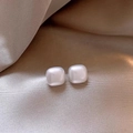 Elegant white square pearl stud earrings on a soft beige silk fabric background - White Square Pearl