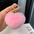Close-up of fluffy pink heart-shaped faux rabbit fur keychain with gold ring - Water Pink