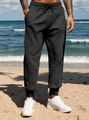 Close-up of black men's joggers featuring drawstring waist and elastic cuffed ankles - Black