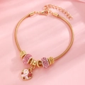 Detail of gold charm bracelet with pink rhinestone beads and breast cancer ribbon heart - Gold Heart Pink Ribbon Snake Chain Bracelet (2133)