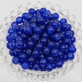 Macro view of blue glass beads with central drill holes in a clear glass dish - 4mm / Dark Blue
