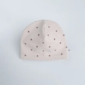 Beige cotton infant beanie with brown polka dots and a small brand label on the side - Dot