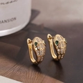 Golden snake head earrings with white cubic zirconia and green gem eyes for women - Gold