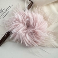 Detailed view of a soft grey-pink faux fur scrunchie with a fluffy feather texture - Pink