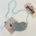 Close-up of heart-shaped blue fabric bag with butterfly embroidery and metal snap - Azure