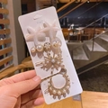 Detail of 5-piece gold hair clip set with pearls and pink starfish on card holder - Double Starfish 5-piece Set