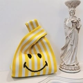 Knitted tote bag with yellow and white stripes and a black smiley face pattern - Yellow Stripe Smile