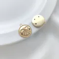 Macro detail of 14K gold plated bow pendant with colorful zircons on white silk background - Color CZ Bowknot Round Pendant 14.8mm