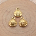 Three golden shell pendants for jewelry making on a rustic wood background - Antique Gold