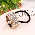 Elegant gold ponytail cuff hair tie with rows of sparkling crystals on a black elastic band - Zirconia Style / Silver