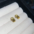 Close-up of yellow emerald-cut gemstone stud earrings in a beige velvet jewelry box - Small / Yellow