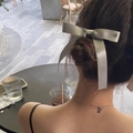 Elegant silver ribbon bow hair tie with pendant worn by a woman in a cafe setting - Large Hair Clip / Gray