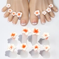 Detailed view of silicone toe separators with white and orange floral nail art decor - White Flower with Orange Center (Set of 10)