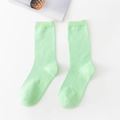 Pastel light green cotton crew socks with ribbed texture for women on white background - Emerald Light Green