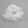 Detail view of a white translucent chiffon hair scrunchie with soft fabric texture - White