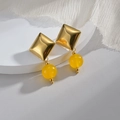 Gold rhombus earrings with translucent yellow beads on a minimalist white display - Yellow