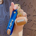 Rugby sports keychain with blue silicone wrist strap and brown football pendant - Rugby Ball