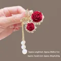 Detail of red velvet rose hair claw with butterfly crystals and pearl tassels - M36 Cherry Pearl