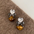 Macro view of heart crystal and tiger eye stone earrings on brown knit background - Silver Needle-Silver-Coffee