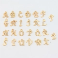Flat lay of 26 golden alloy alphabet pendants with rhinestones for DIY jewelry making - Rhinestone Alphabet Set (DY147) / Set of 26 / Style 73 Irregular Rhinestone Letter KC Gold