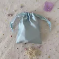 Detail of light blue satin drawstring pouch for jewelry storage with smooth silk finish - 15.5*11.5 / Fashion Blue