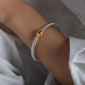 Two-tone cable twist bangle with golden center and marquise green zircon stone inlay - Green Zirconia