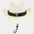 Close-up of straw cowboy hat featuring vintage bull head metal ornament and leather band - Ivory