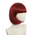 Detail of red short bob wig with straight bangs on a mannequin head against white background - Red