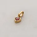 Golden heart-shaped pendant featuring a red garnet gemstone for January birthdays - January Heart Pendant - Gold