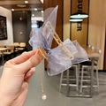 Close-up of golden hair claw with large purple mesh bow and white pearl pendant fringe - Bow Claw Clip / Light Blue Grey