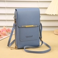 Close-up of fog blue touchscreen phone crossbody bag with gold metal trim and double zippers - Blue
