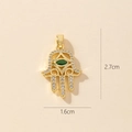 Detailed size view of golden Hamsa Hand pendant with zircon stones, 2.7cm by 1.6cm - 0371-11/Green Zircon Hollow Hamsa